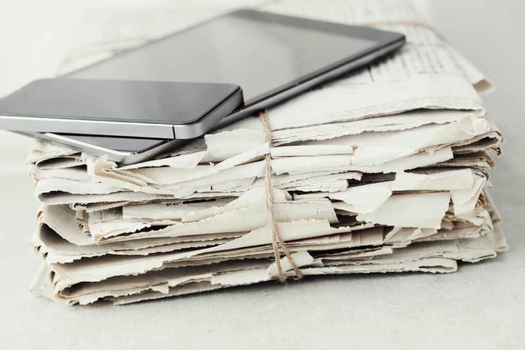 stack newspapers with digital tablet smartphone 1024x683 1